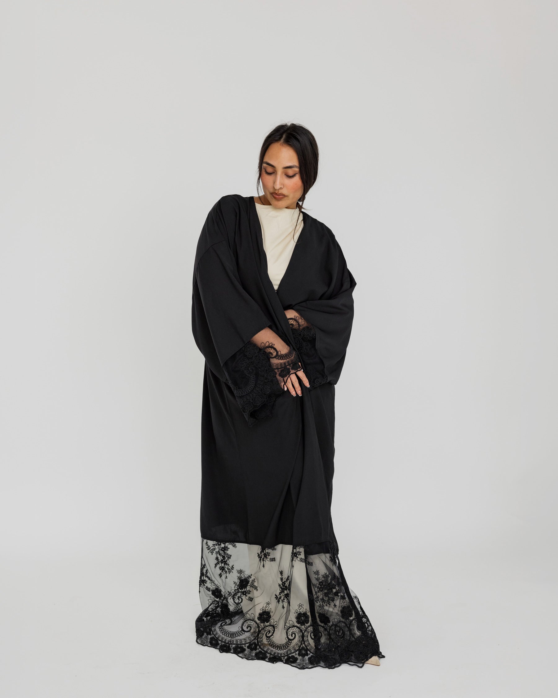 Lace-trimmed abaya with flowing fabric and delicate detailing for a refined finish.