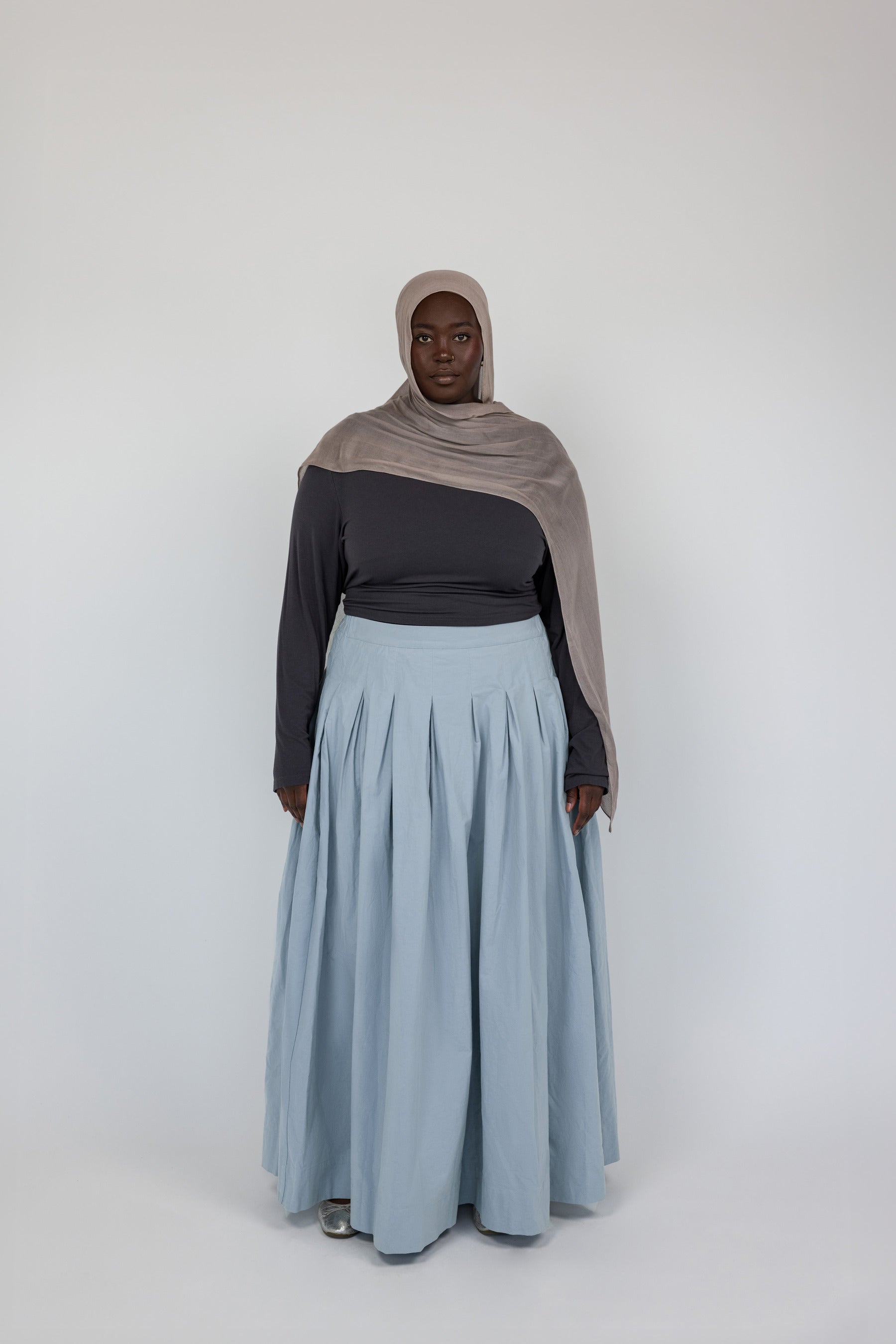 Structured cotton skirt with full pleats that move naturally and hold their shape.