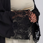 Elegant abaya featuring soft draping and subtle lace accents along the edges