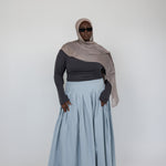 Full-length cotton skirt with wide pleats and a structured, flowing shape.
