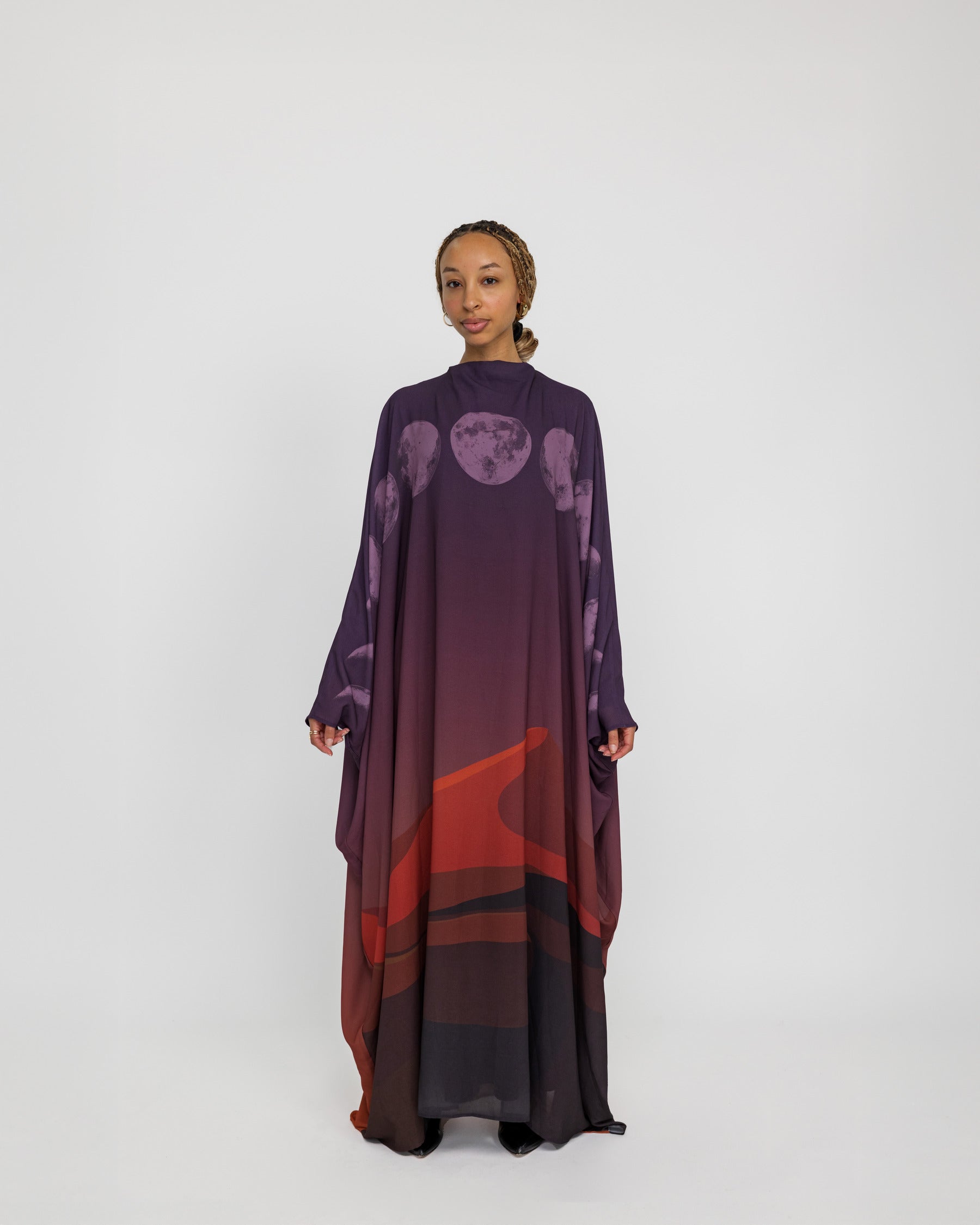 Sheer kaftan abaya with moon phase detailing, inspired by desert skies and lunar cycles