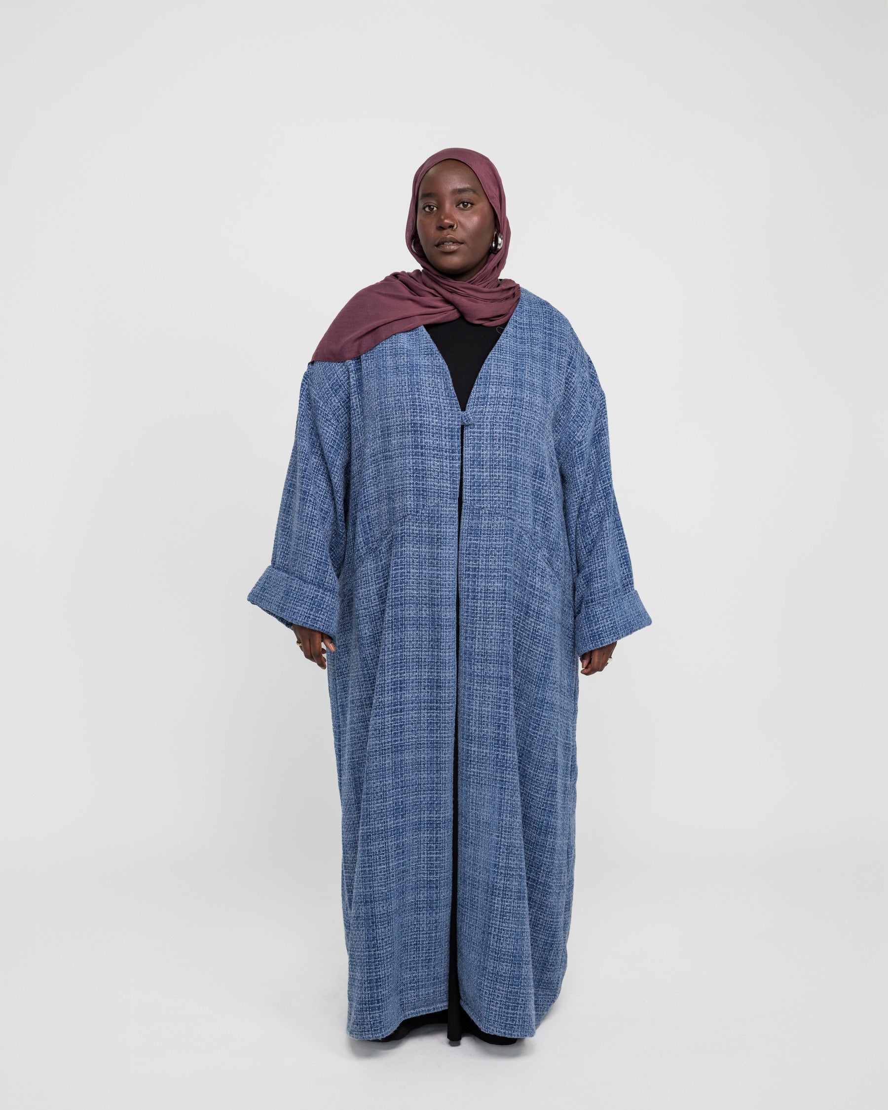 Layering abaya made from structured tweed, blending warmth with refined design