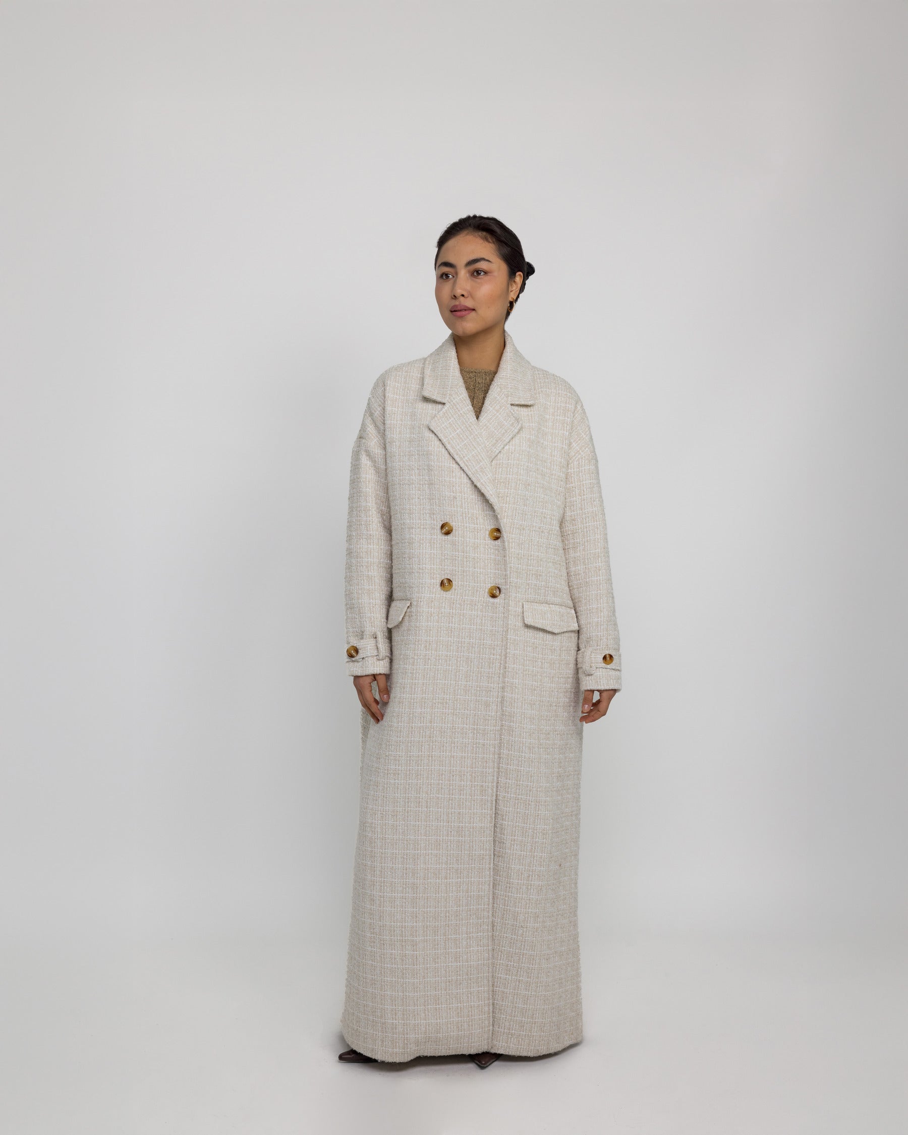 Oversized trench-style abaya coat with tailored details and fluid structure