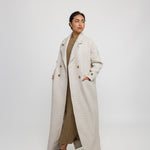 Outerwear abaya designed with trench coat elements and a soft, draped fit