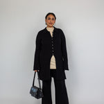 Modest open-front cardigan featuring a structured knit and relaxed longline cut