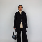 Modest open-front cardigan featuring a structured knit and relaxed longline cut