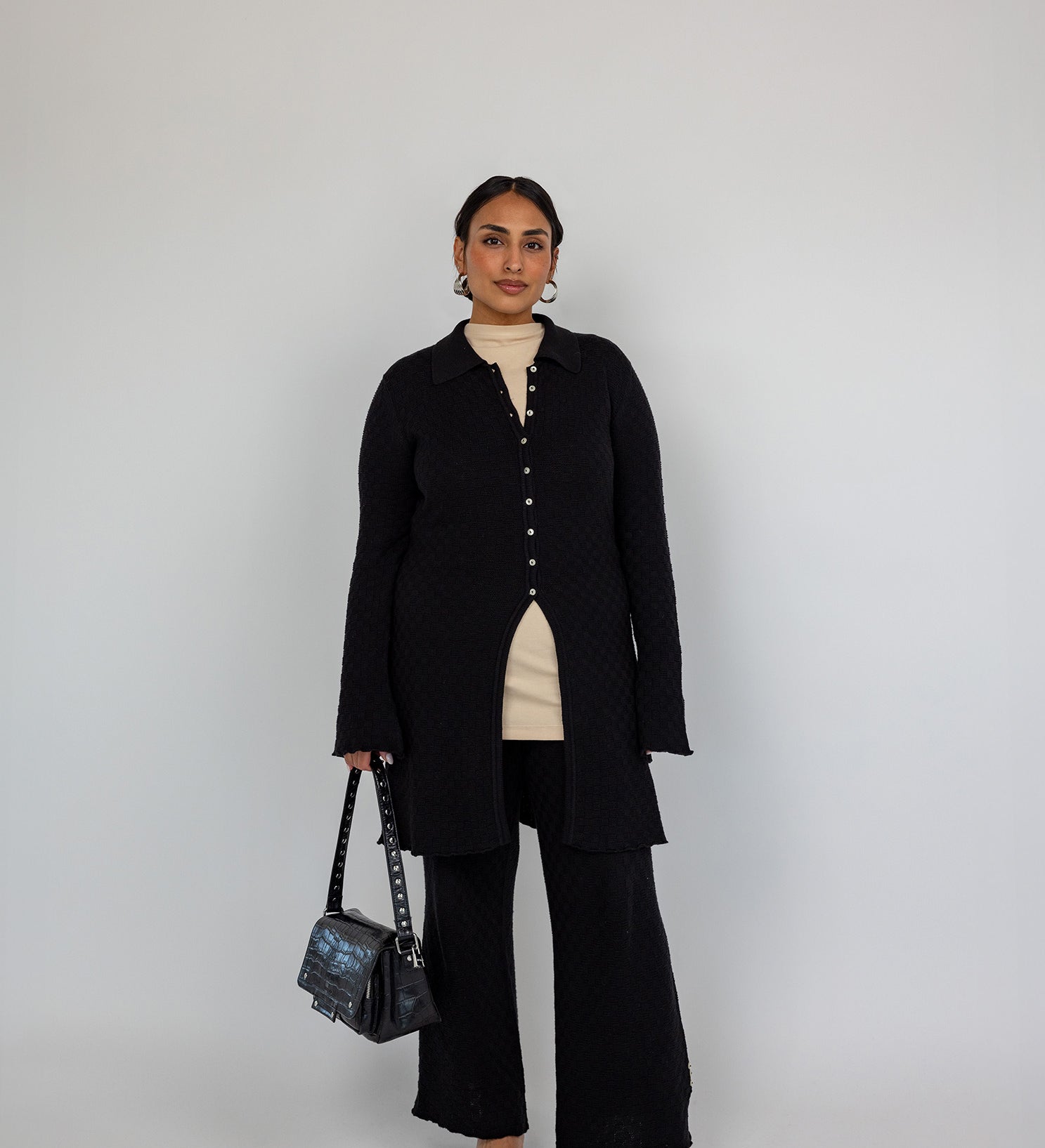 Modest open-front cardigan featuring a structured knit and relaxed longline cut