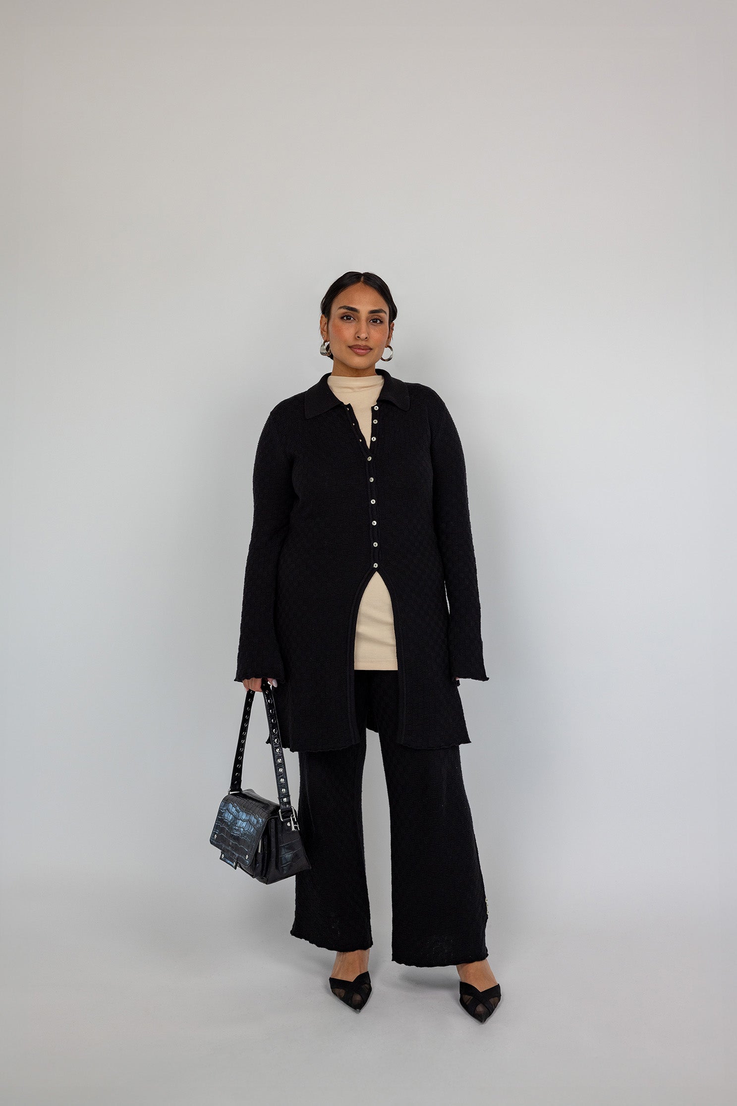 Modest open-front cardigan featuring a structured knit and relaxed longline cut