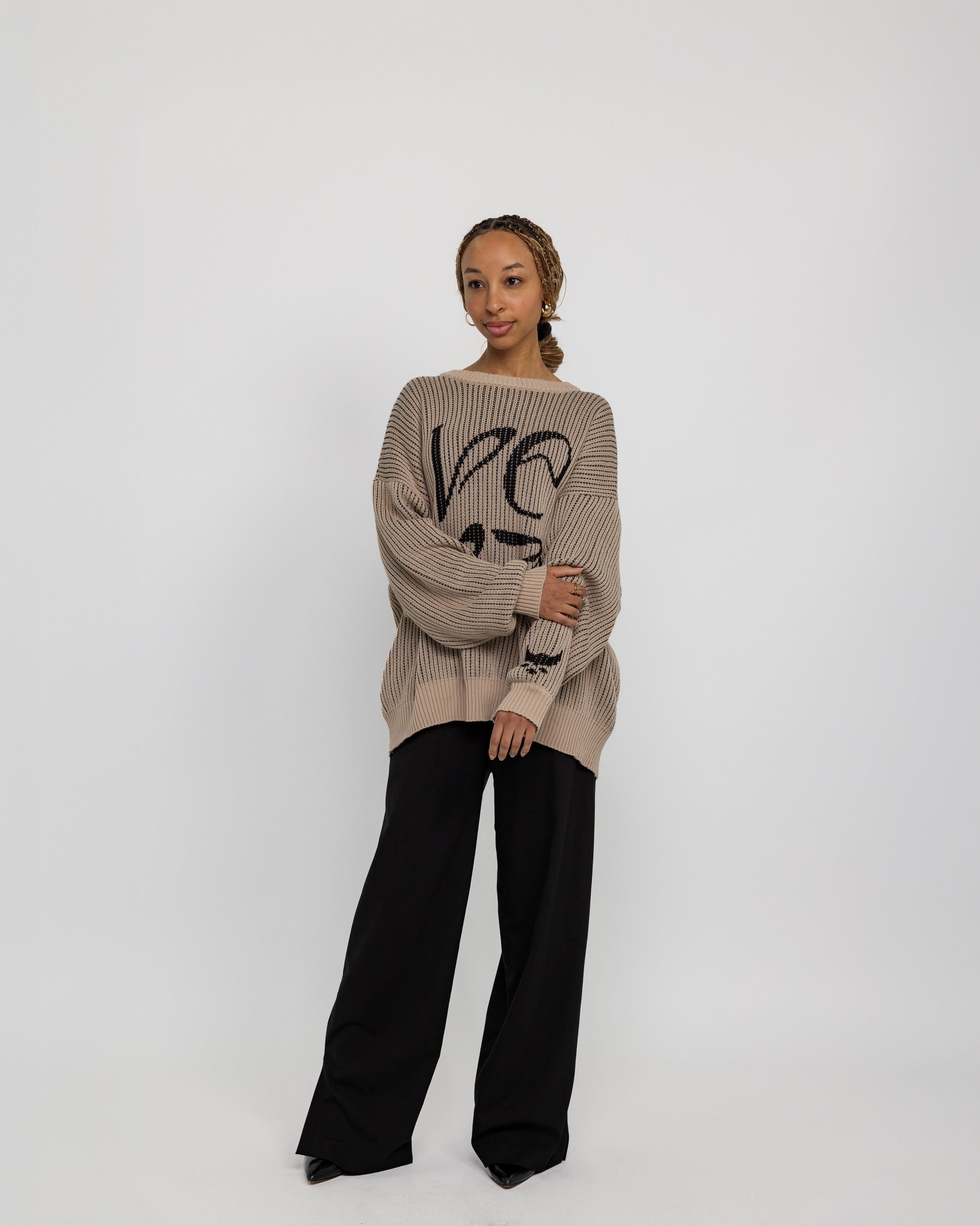 Modest knit sweater with a flowing, oversized shape and heritage-inspired design