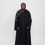 Statement abaya featuring delicate sparkle and flowing flared sleeves