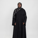 Statement abaya featuring delicate sparkle and flowing flared sleeves