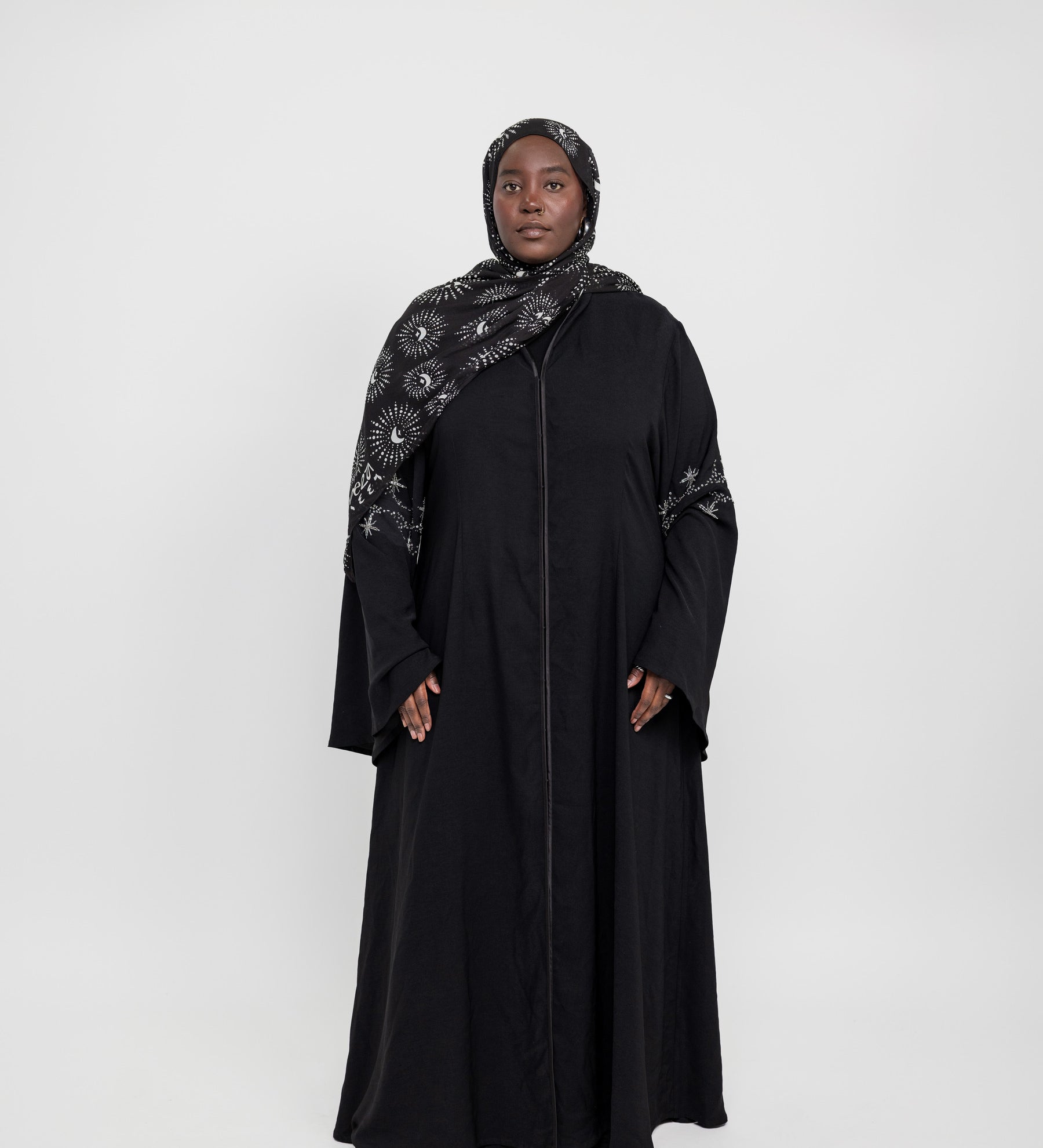 Statement abaya featuring delicate sparkle and flowing flared sleeves