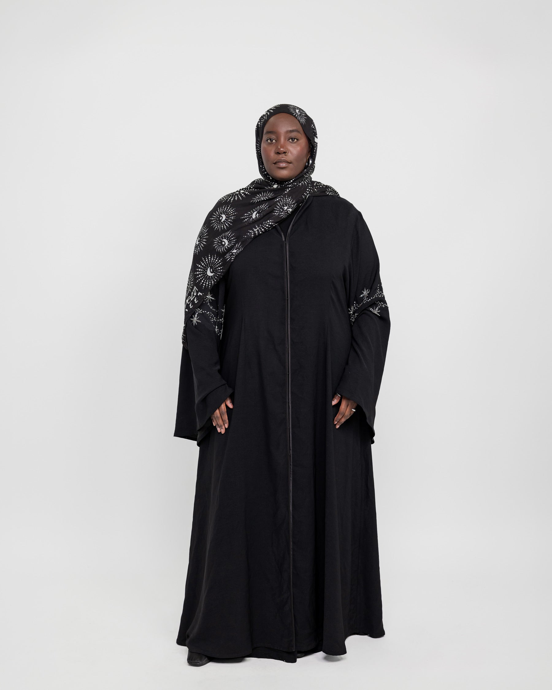 Statement abaya featuring delicate sparkle and flowing flared sleeves