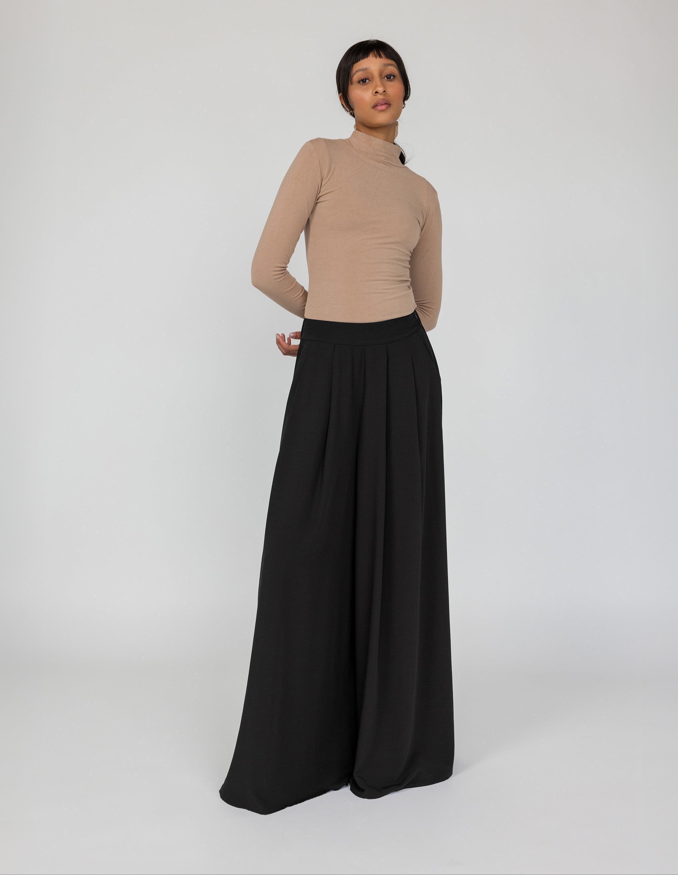VELA wide-leg palazzo pants with soft drape and modest full-length fit.