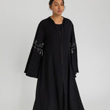 Jeweled abaya with a modest, fluid shape and elegant sleeve flare