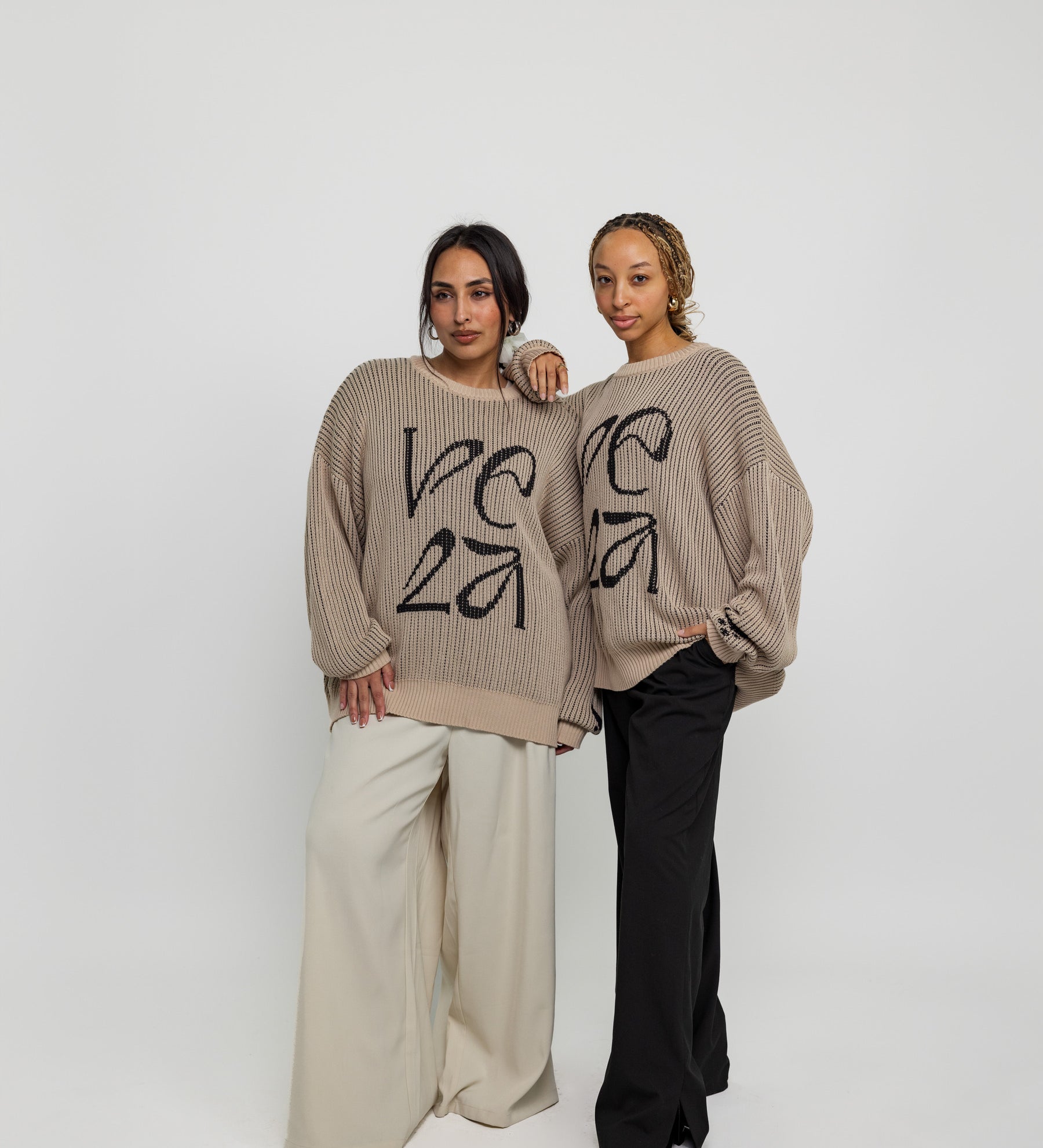 Oversized sweater with arabesque-inspired knit design and subtle stitched logo detail.