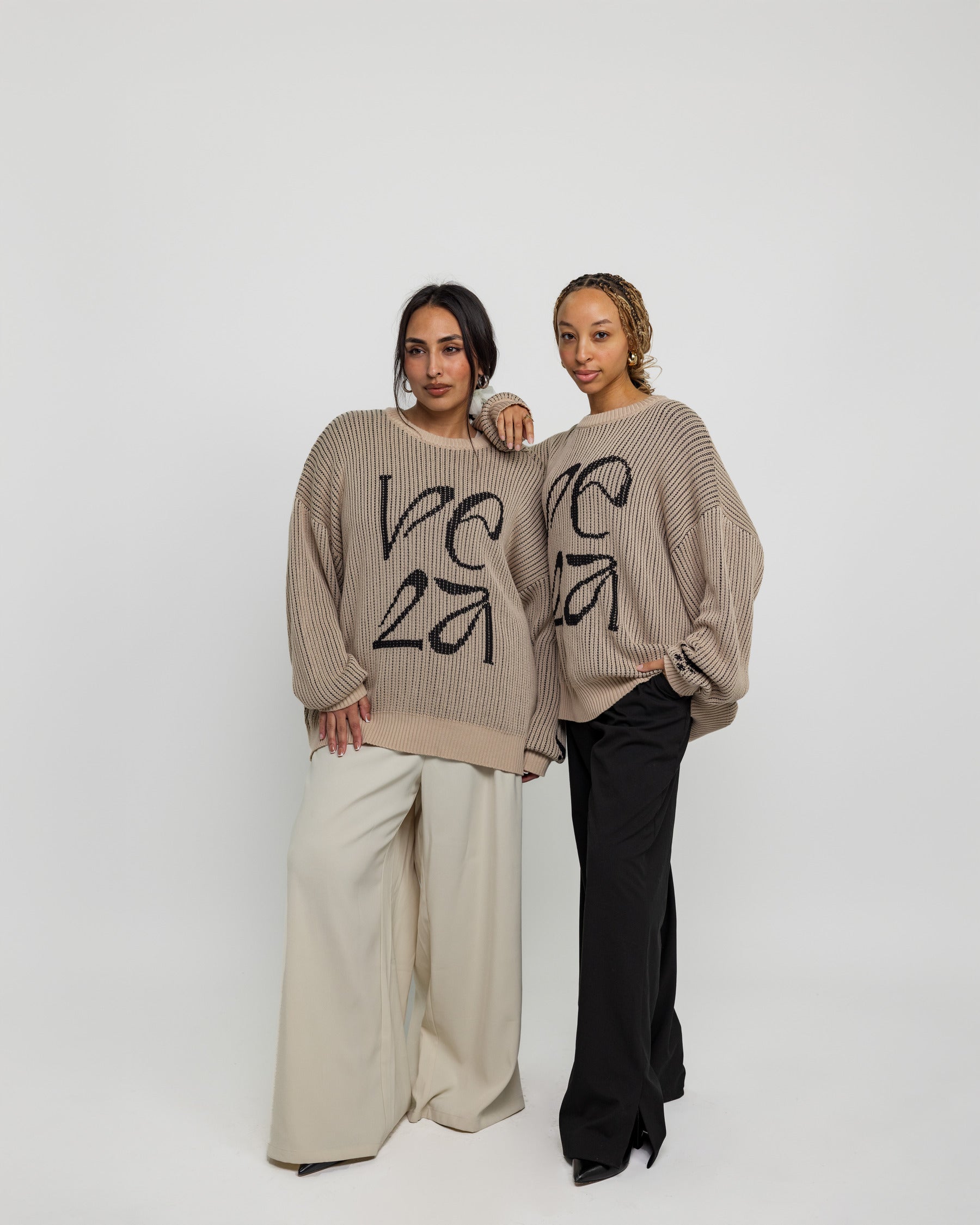Oversized sweater with arabesque-inspired knit design and subtle stitched logo detail.