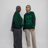 Soft oversized sweater with traditional pattern influence and modern comfort.