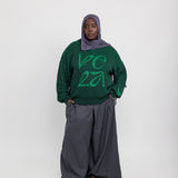 Relaxed-fit sweater featuring intricate woven patterns and cozy, soft texture