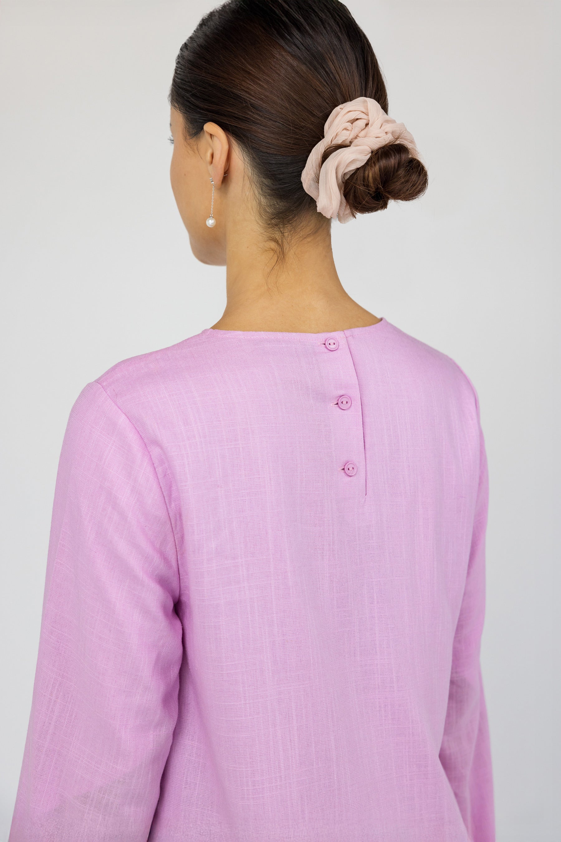 Modest top with tie-front detail and natural texture, perfect for layering in warm weather