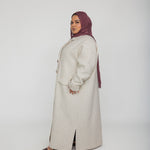 Layering abaya coat with trench-style lines and a modern, oversized shape
