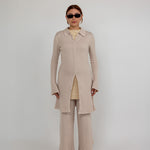 Fitted knit cardigan with a check pattern and modest full-length coverage.