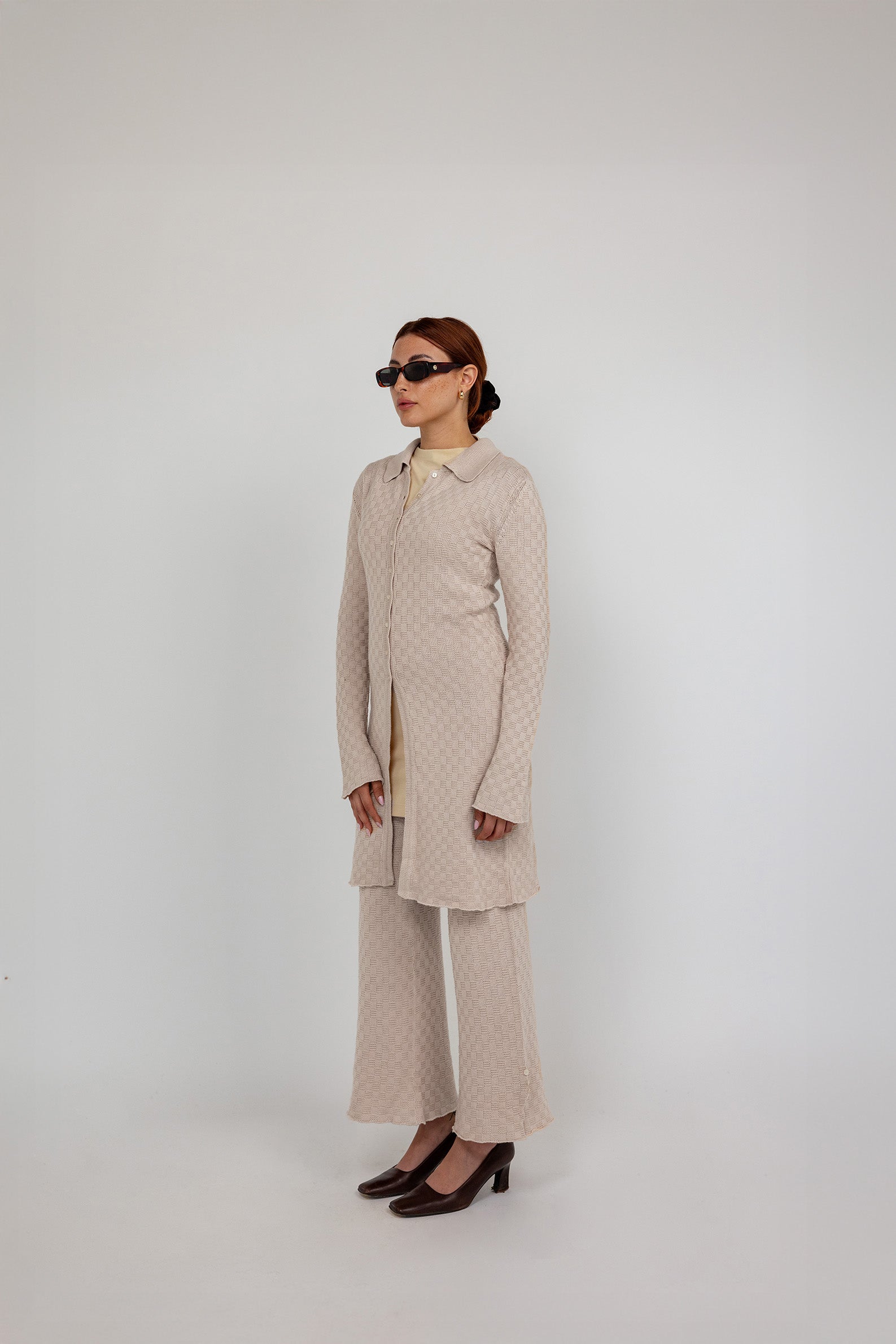 Longline checkered knit cardigan with a tailored fit and soft, breathable fabric.
