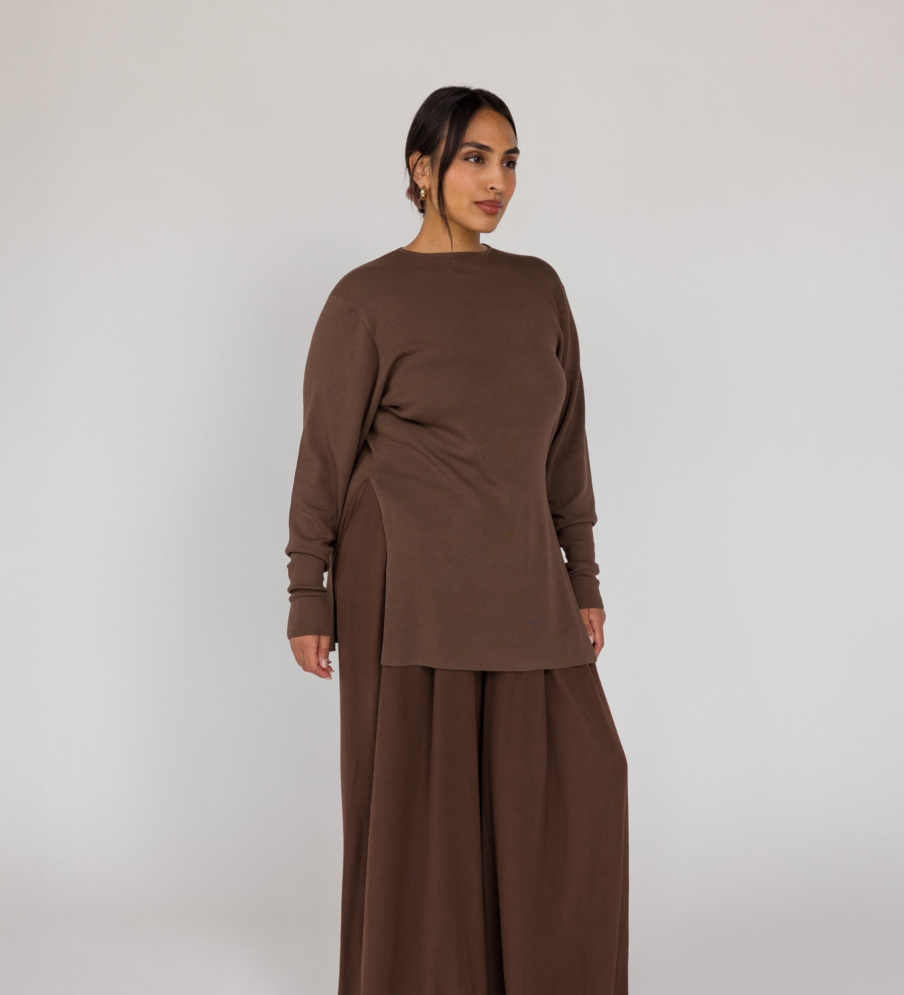 Woman wearing a brown outfit on a white background