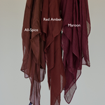 Maroon hijab hanging next to other shades for a side-by-side comparison of color depth and tone.
