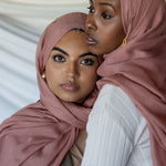 Two models wearing Blush hijab in front of backdrop.