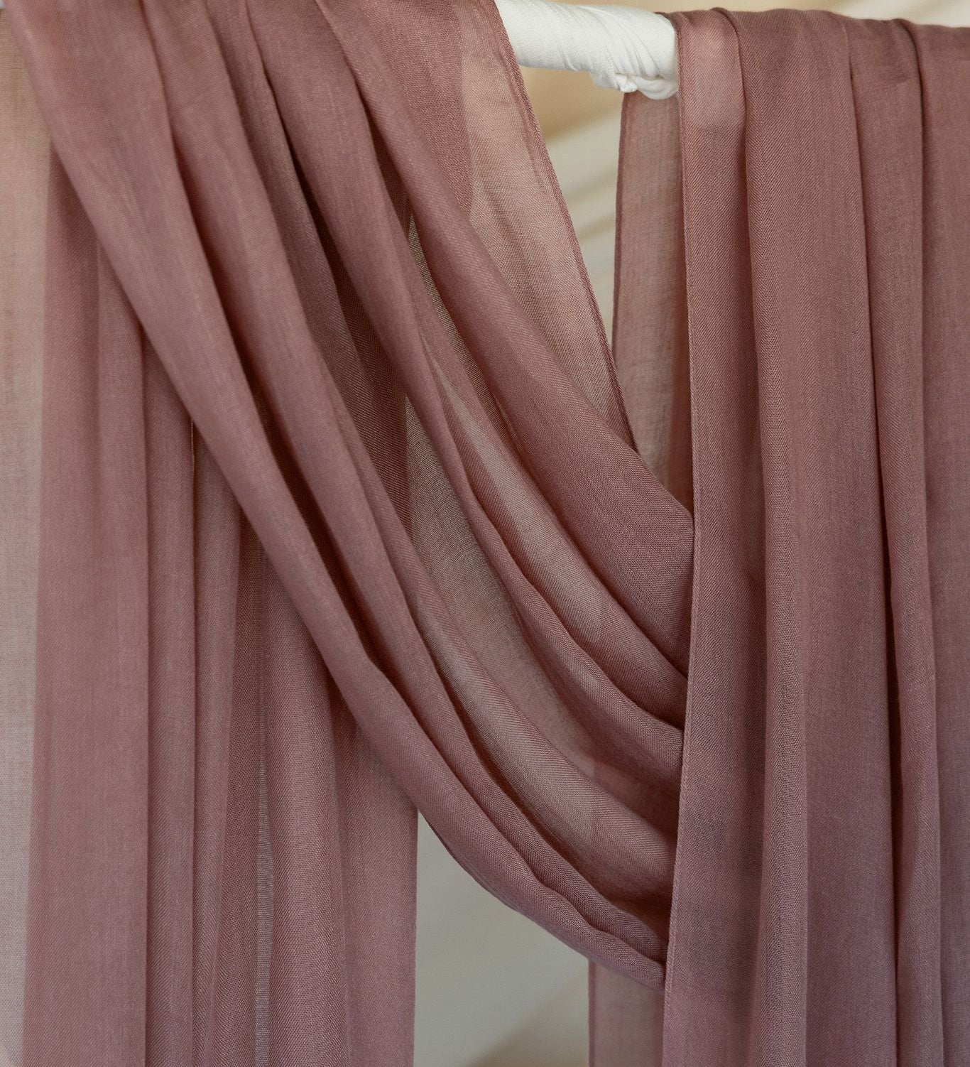 Blush hijab close up of product draped against backdrop.