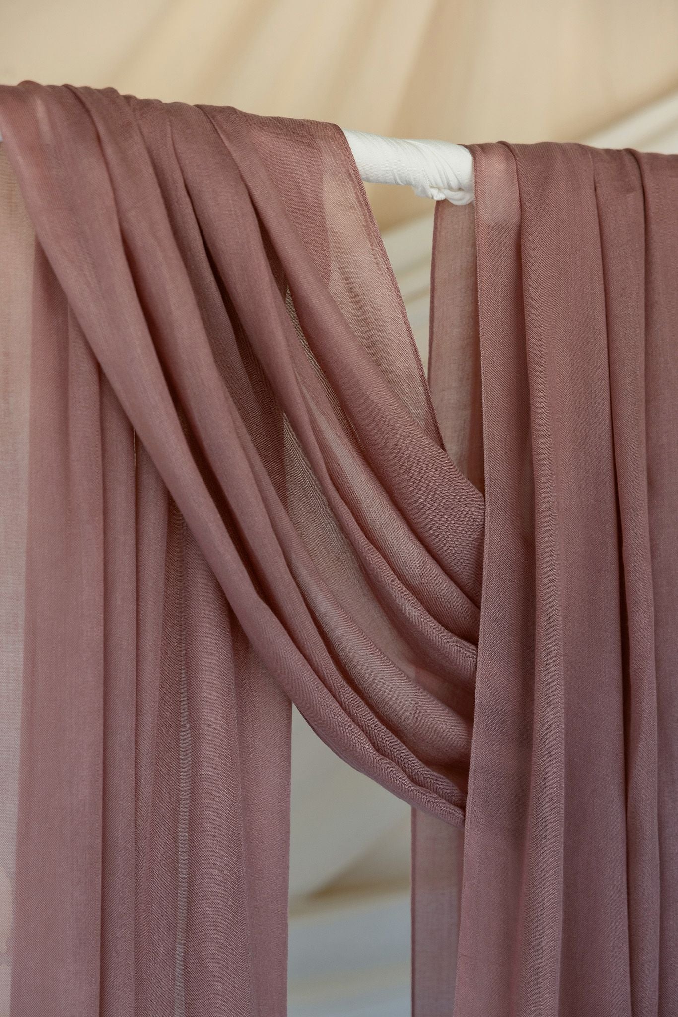 Blush hijab close up of product draped against backdrop.