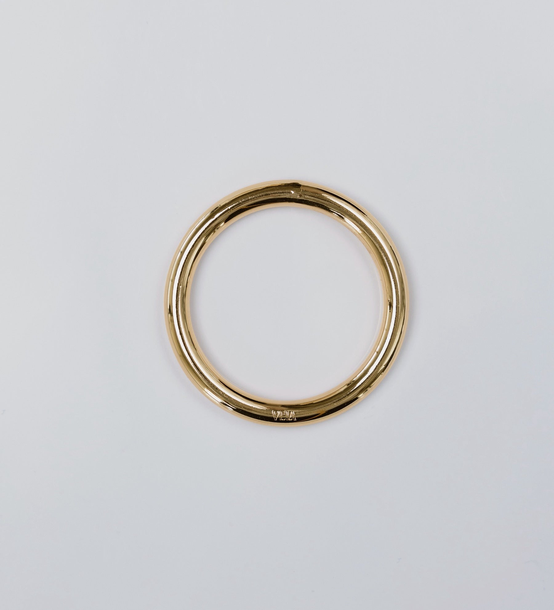 Gold hoop on a light gray background