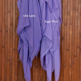Color comparison shot of two purple hijabs draped over a wooden surface with 'Ube Latte' and 'Sugar Plum' labels.