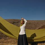Model wearing Guava Green hijab standing in field.