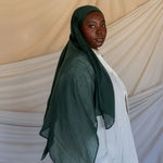 Model wearing smooth modal hijab with a subtle sheen and soft, relaxed movement.