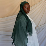 Model wearing smooth modal hijab with a subtle sheen and soft, relaxed movement.