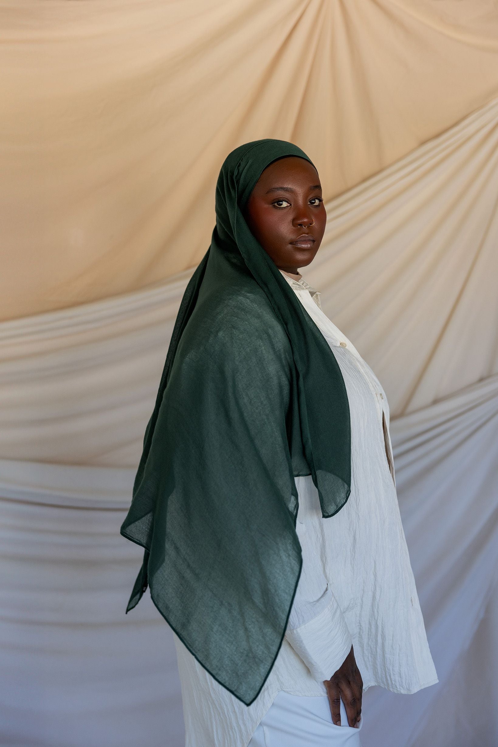 Model wearing smooth modal hijab with a subtle sheen and soft, relaxed movement.