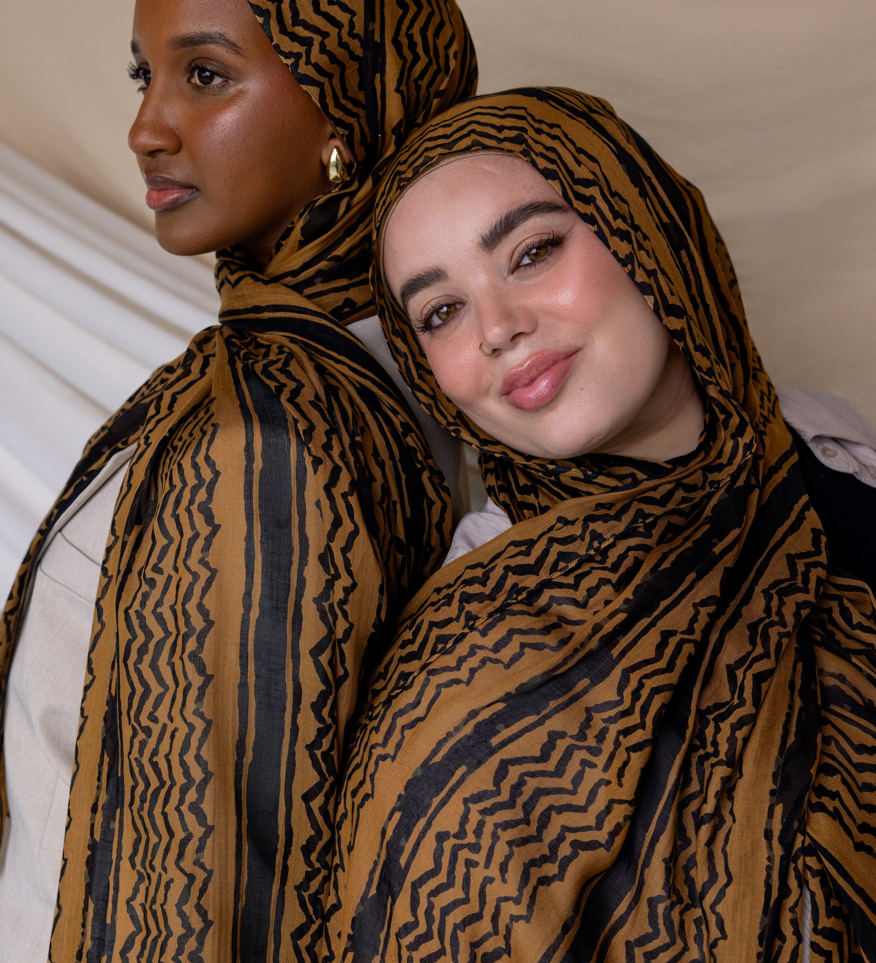 Two Models wearing woven hijab featuring a heritage-inspired print in a modern, watercolor finish.