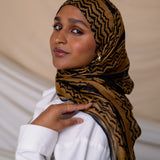 Model wearing VELA hijab designed with ancient motifs in a fresh, artistic execution.