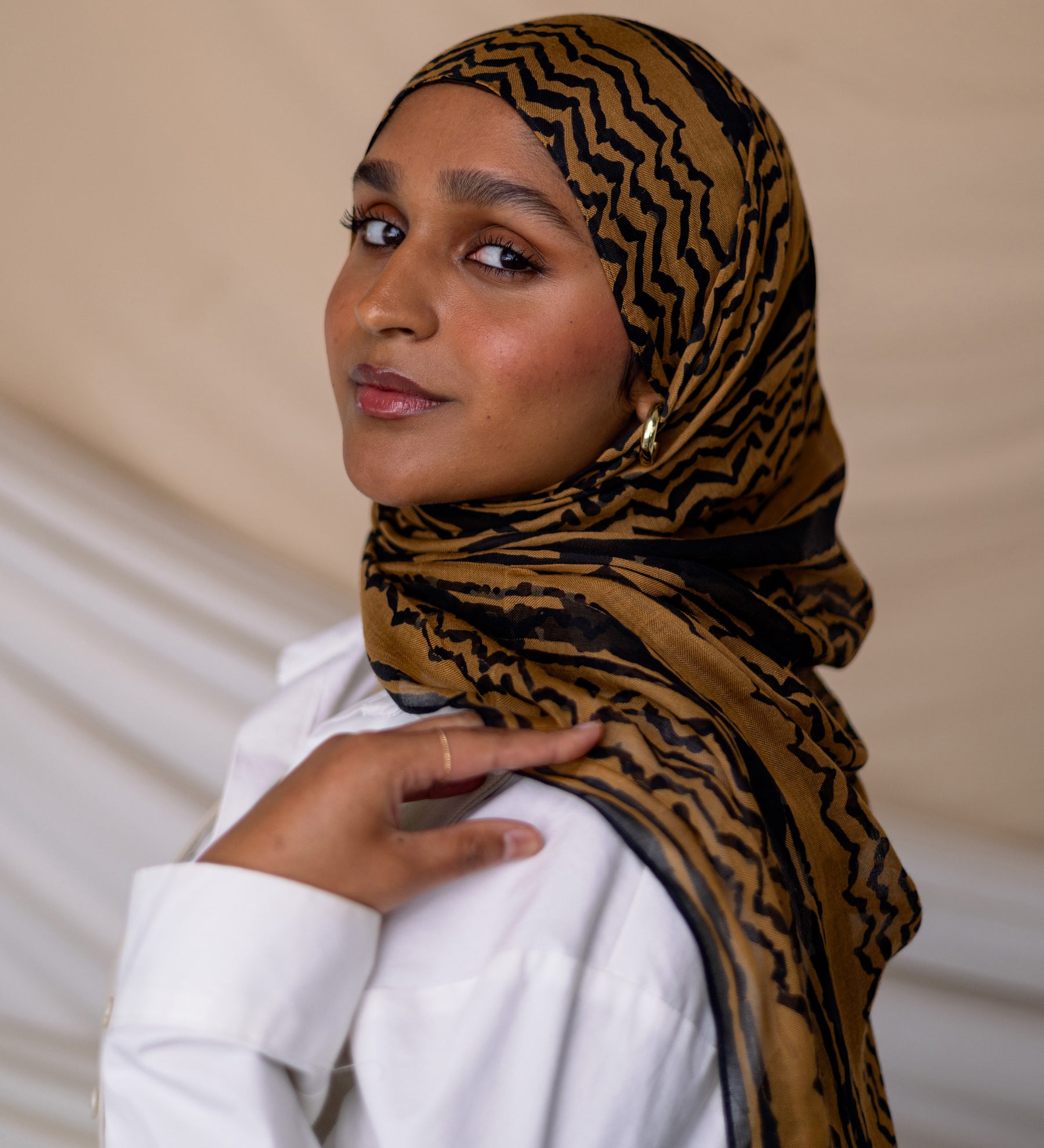 Model wearing VELA hijab designed with ancient motifs in a fresh, artistic execution.