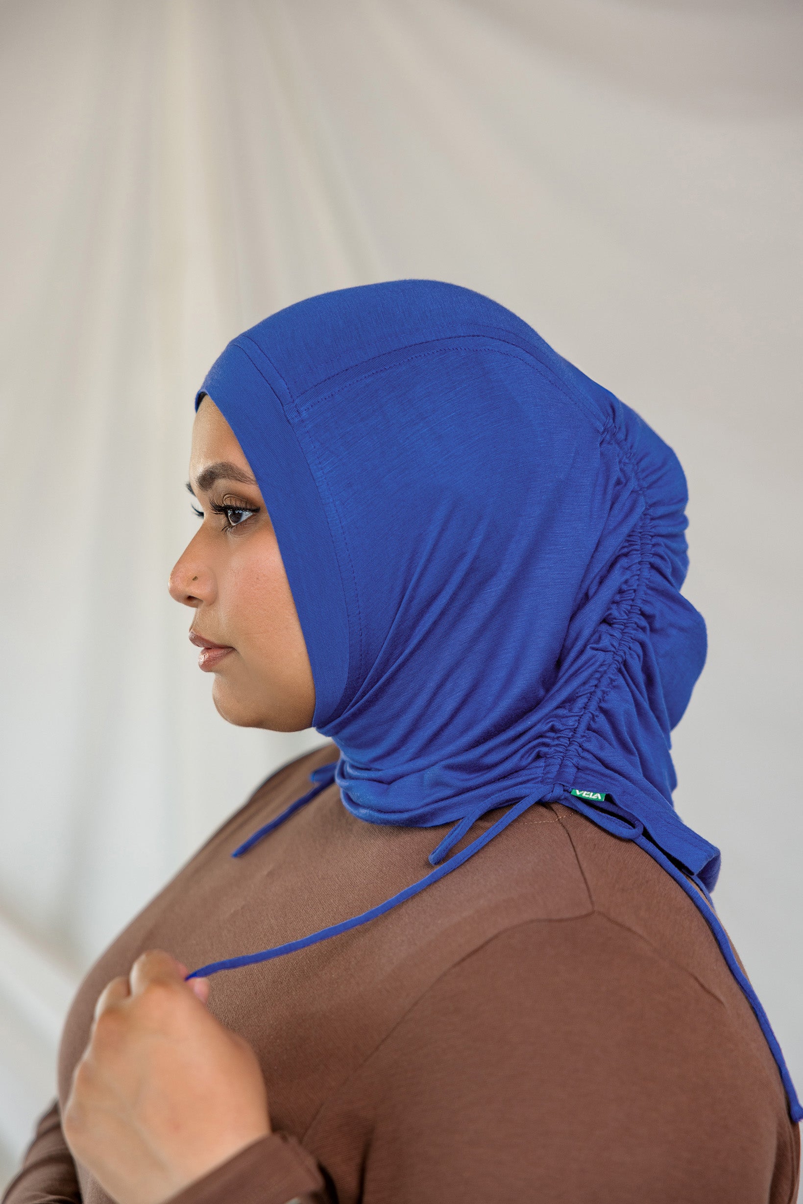 Model wearing Ocean Blue Ruching Lite, displaying the ruching detail.