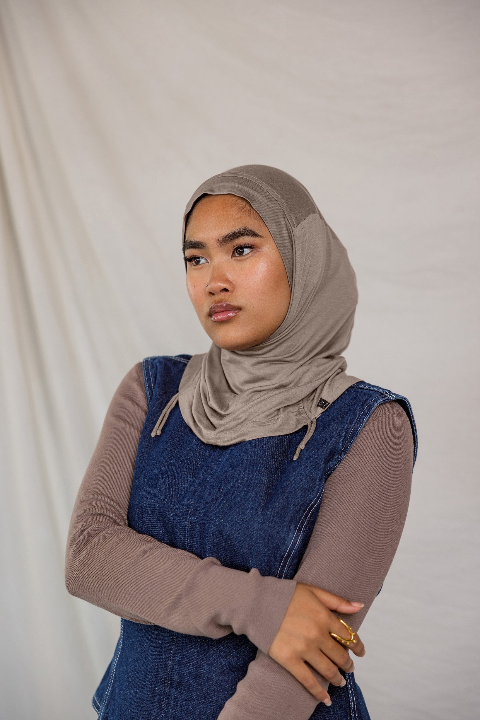 Model wearing Truffle Mink Ruching Lite, showing taupe-grey tone and texture.