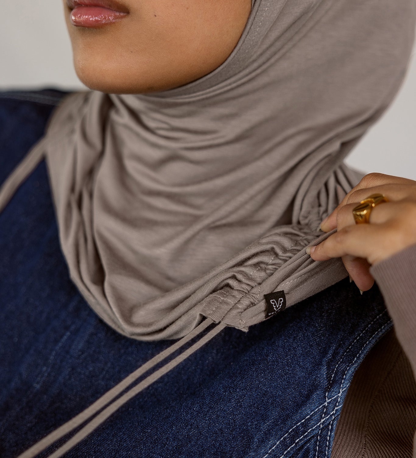 Model wearing Truffle Mink Ruching Lite, highlighting ruching near the edge and soft, lightweight fabric.