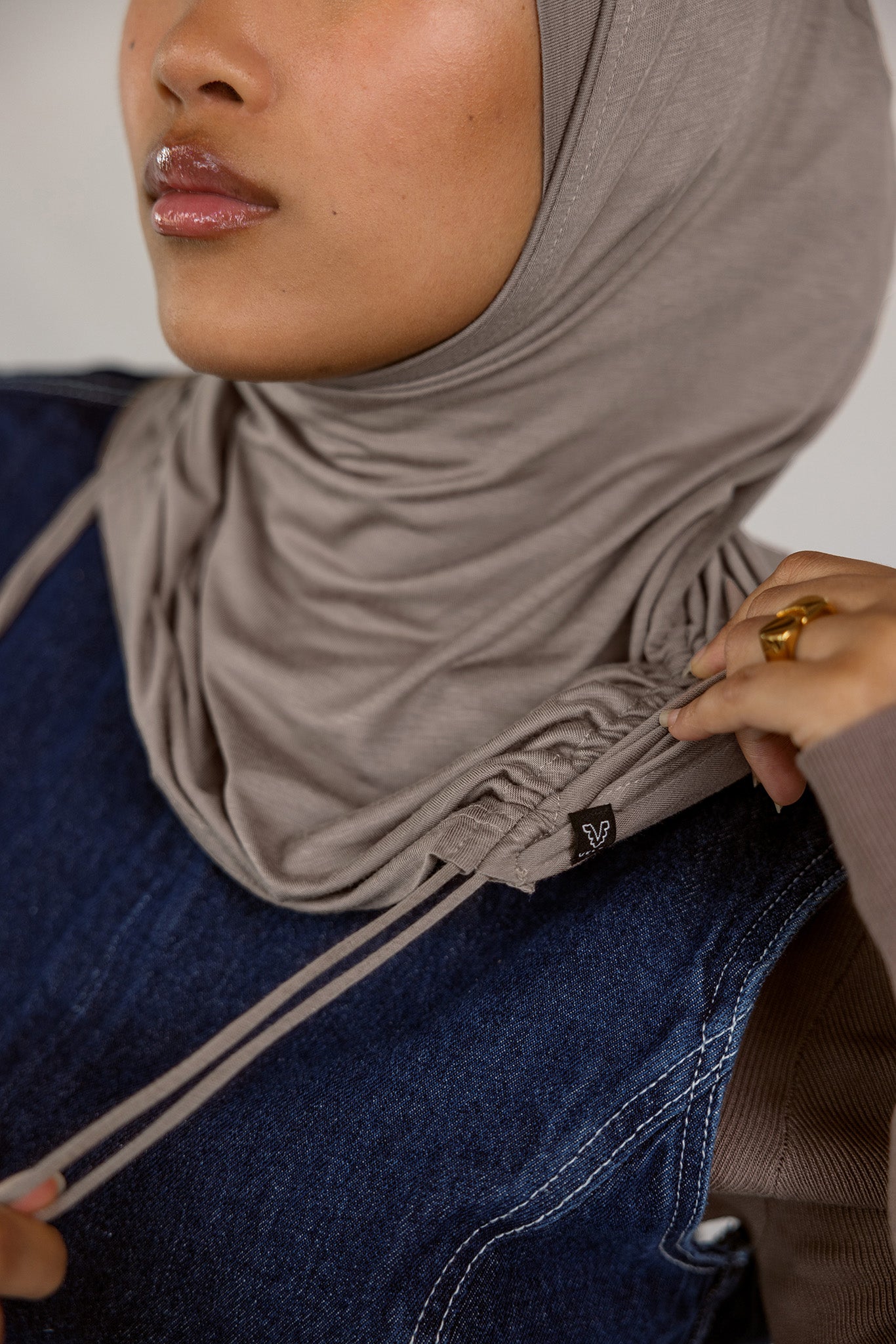 Model wearing Truffle Mink Ruching Lite, highlighting ruching near the edge and soft, lightweight fabric.