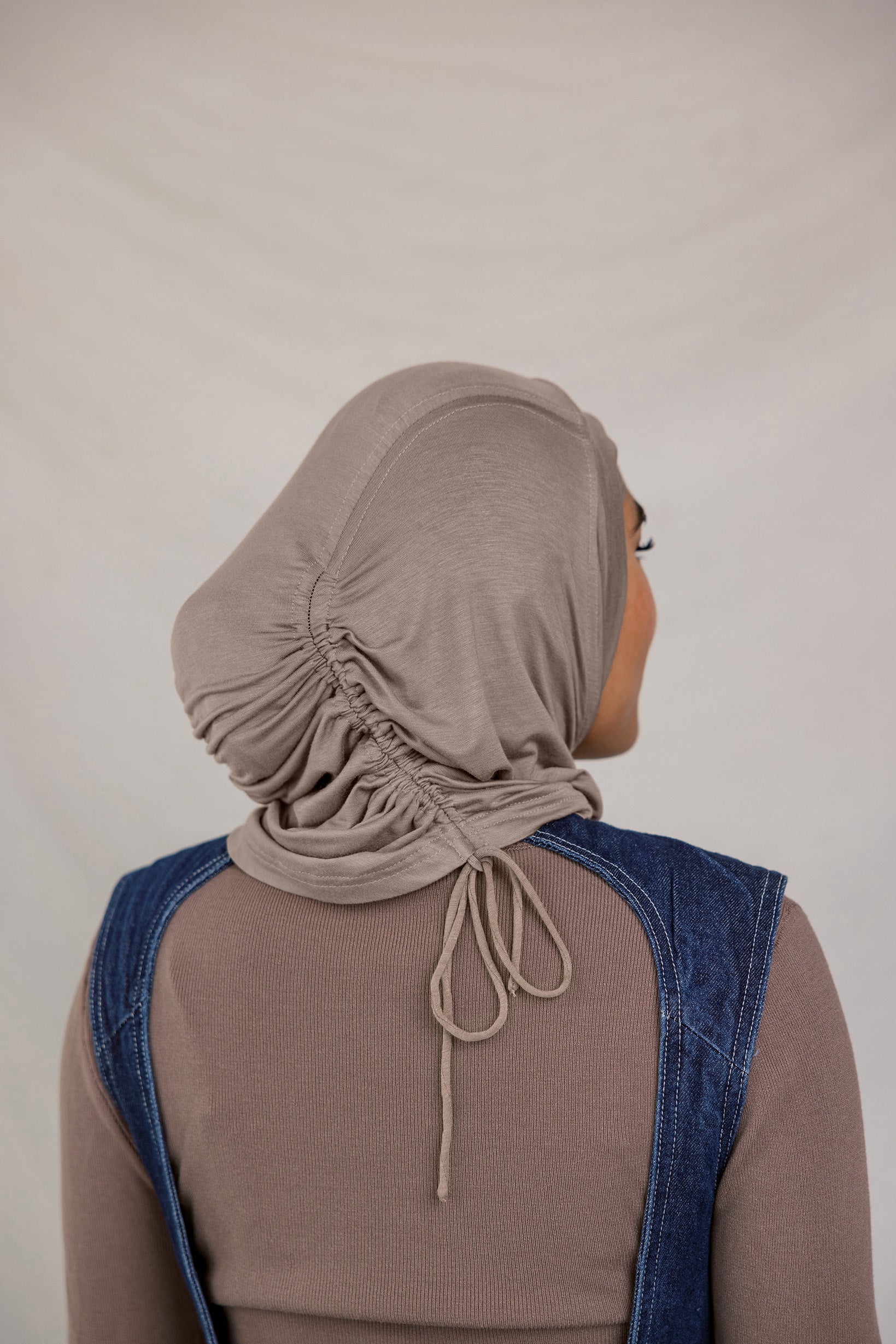 Model showing the Truffle Mink Ruching Lite hijab from the back to show the detail.