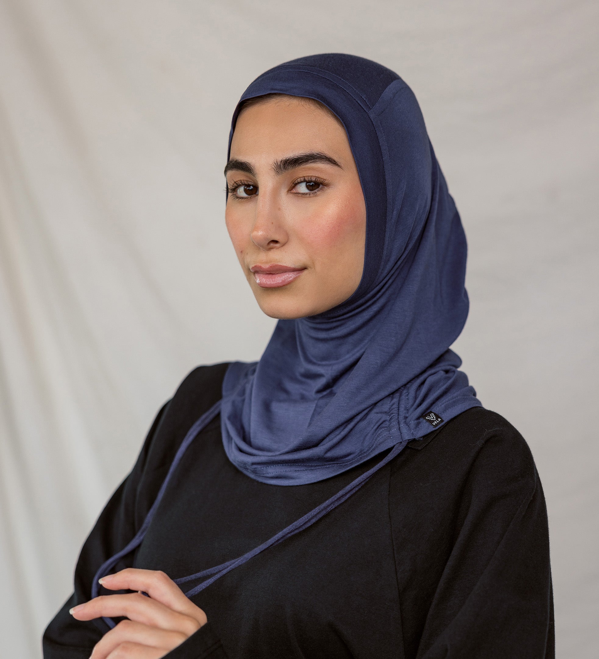 Model wearing Twilight Blue Ruching Lite, highlighting deep navy shade and ruching texture.