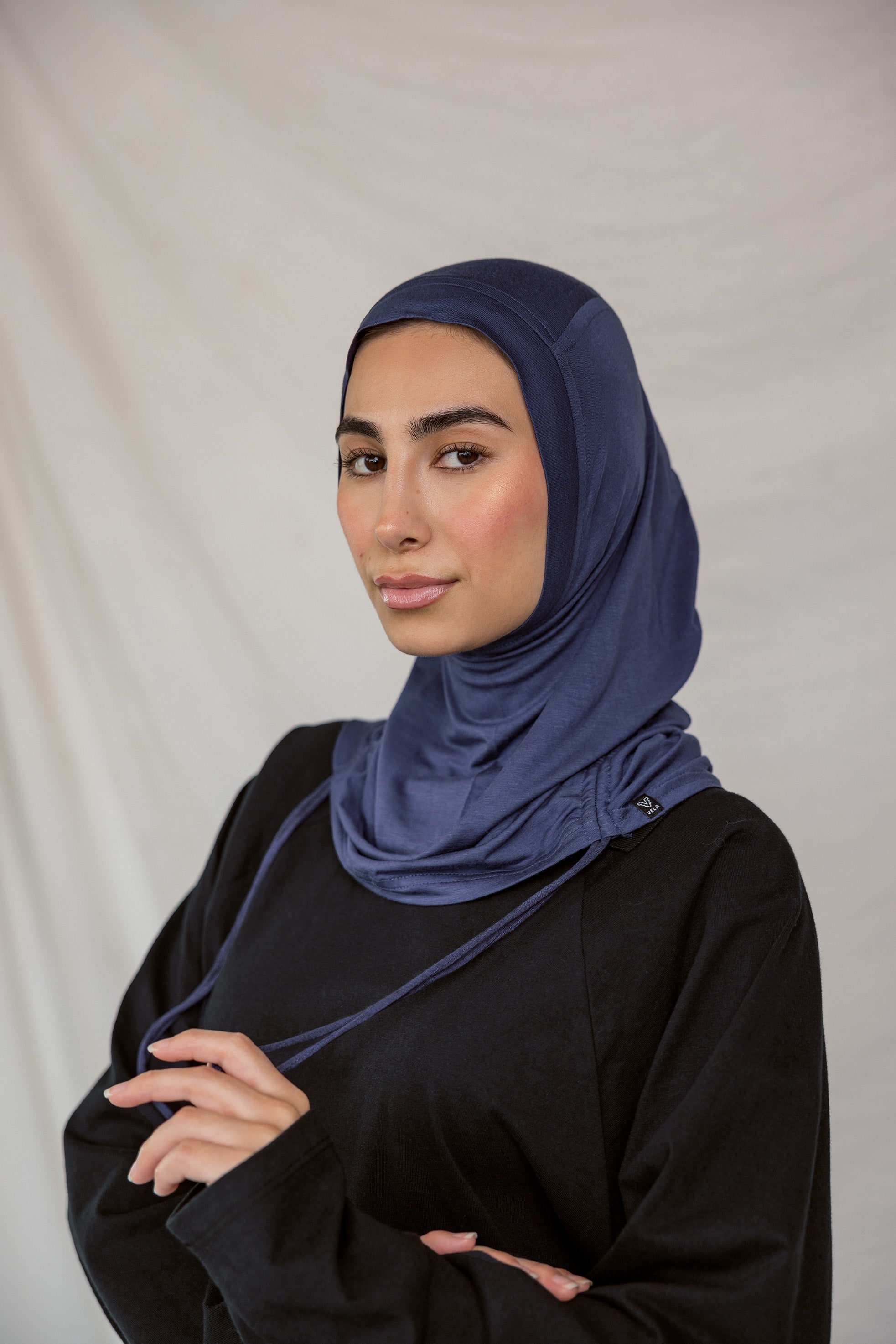 Model wearing Twilight Blue Ruching Lite, highlighting deep navy shade and ruching texture.