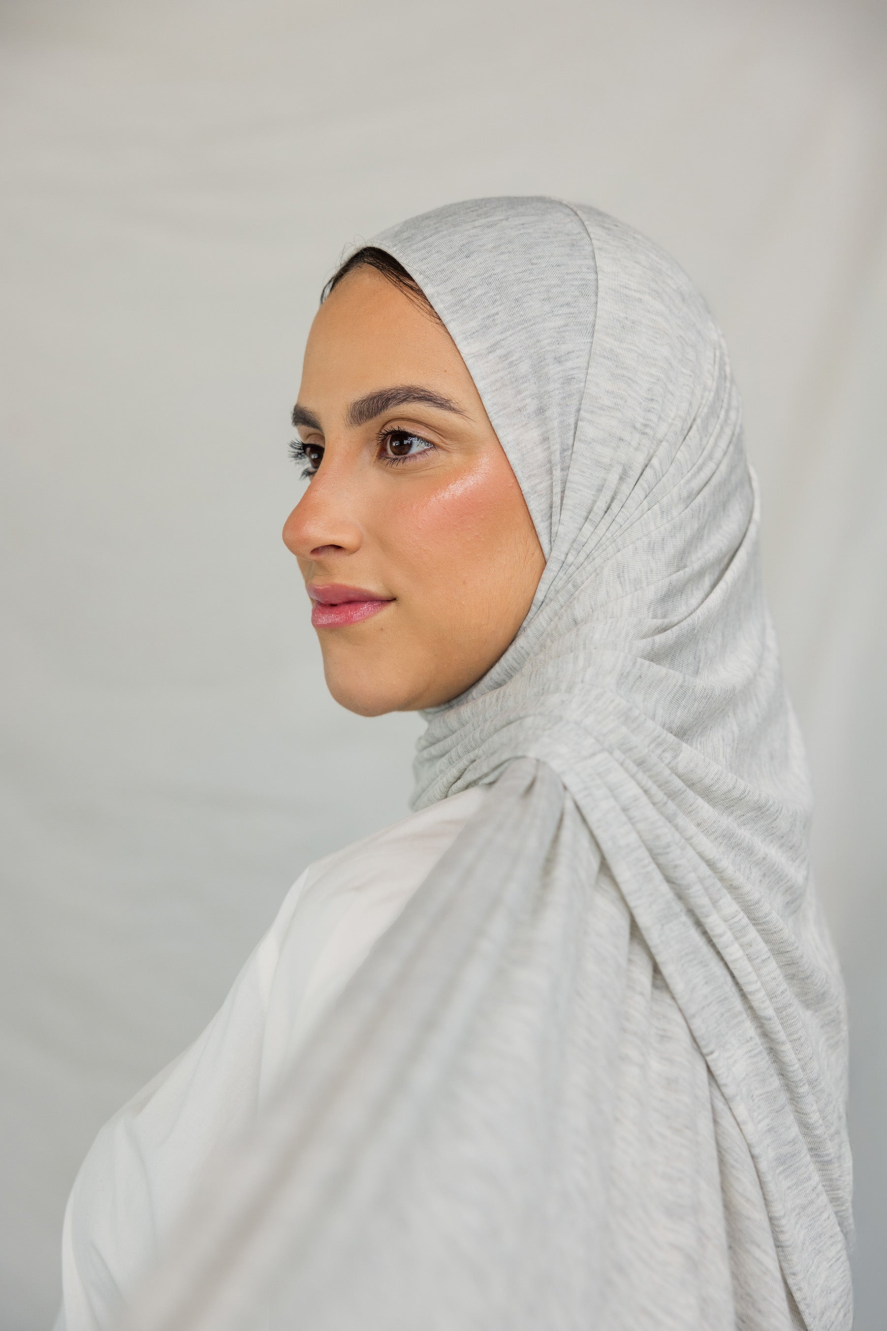 Close-up image of model wearing Marble Grey Jersey Lite draped neatly.