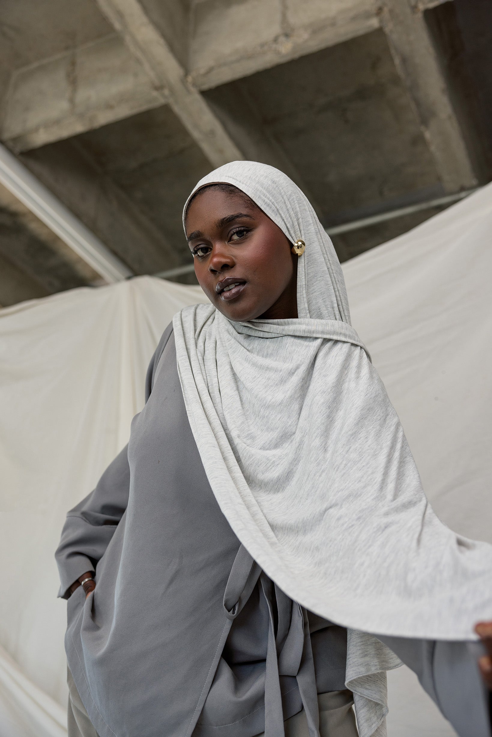 Model wearing Marble Grey Jersey Lite draped neatly, emphasizing its breathable and wrinkle-resistant qualities.